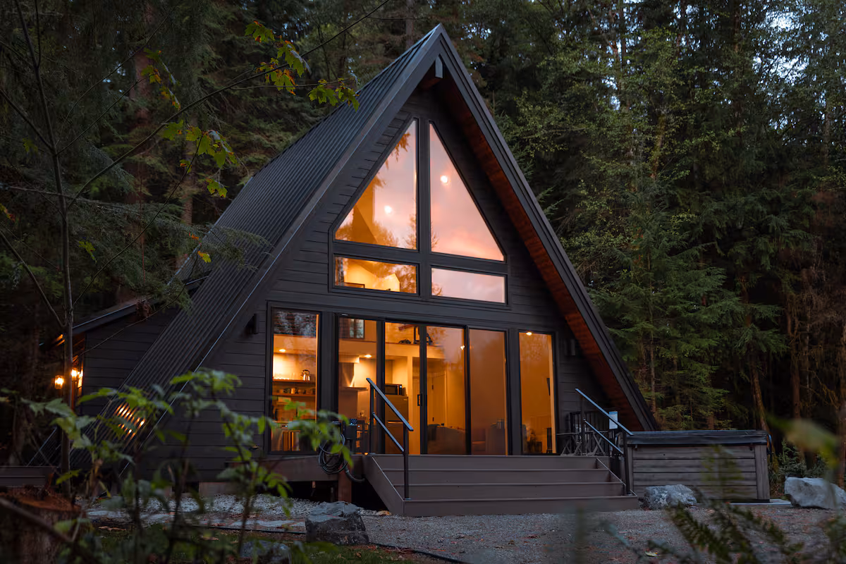 Echo House living room with warm natural wood and a stone fireplace